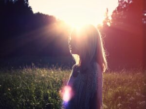 photo of woman on green grass field outdoors during daytime